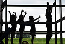 A silhouette of children on a climbing frame