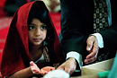 A girl washes her hands with her father