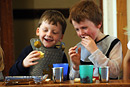 Children in costumes laugh and enjoy their lunch