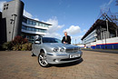 Man poses with a Jaguar car