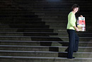 A woman with a health campaign poster with many steps as a backdrop