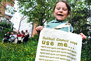 A girl holding a Solihull Council bag takes part in a clean up campaign