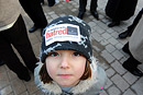 A girl in a hat with a Stand Up to Hatred sticker on it