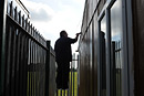 A silhouette of a man painting the outside of a building