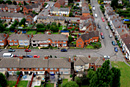 A tilt shift image of residential homes taken from a block of flats