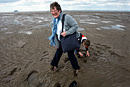 A grandmother and grandson get stuck in the wet sand on the beach