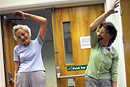 Elderly residents take part in a keep fit class