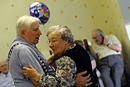 Two elderly residents enjoy a dance during a party