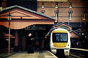 A man at a train station reads his paper