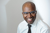 Portrait of a man smiling wearing glasses