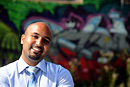 Portrait of a man in front of graffiti on a wall