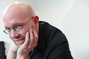 Portrait of a man wearing glasses and a black shirt