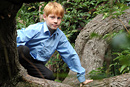 Portrait of a boy climbing trees