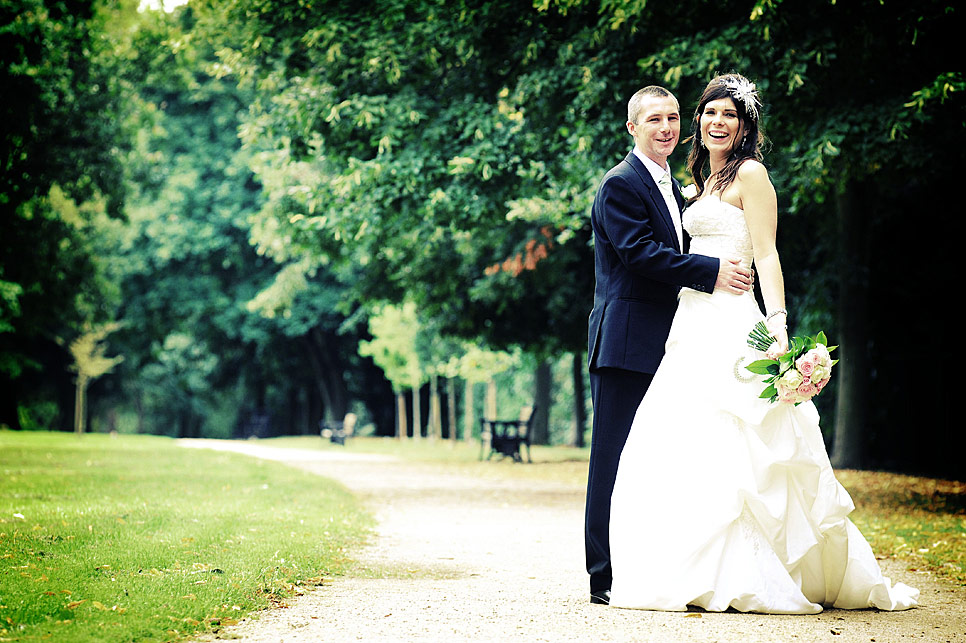 Bride and groom take a walk in the park