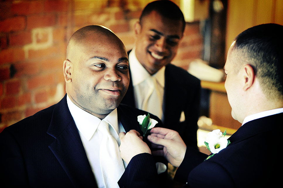 The groom adjusting a buttonhole