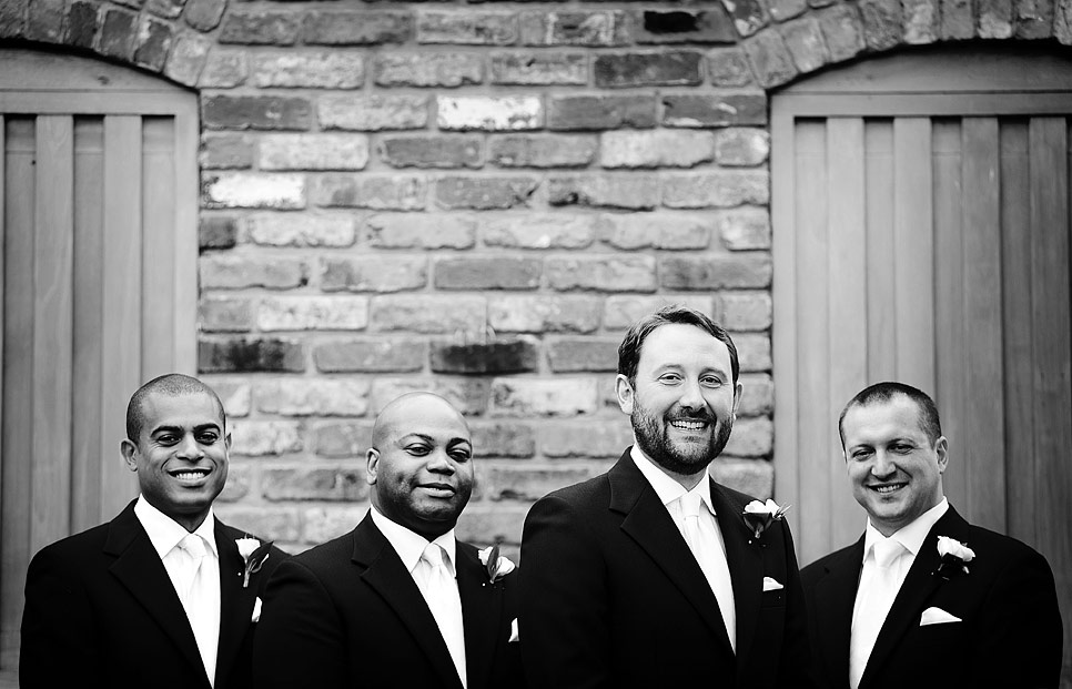 A happy groom with nervous ushers